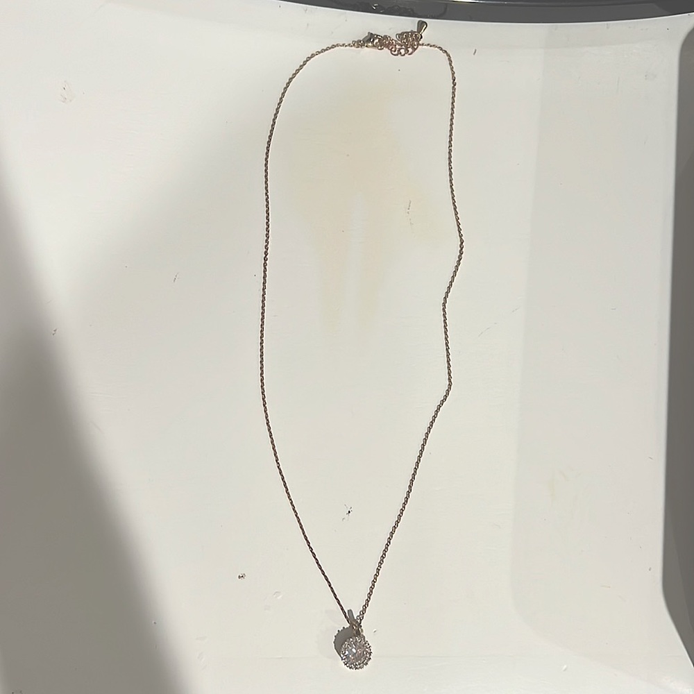 has a gold chain, diamond circle
